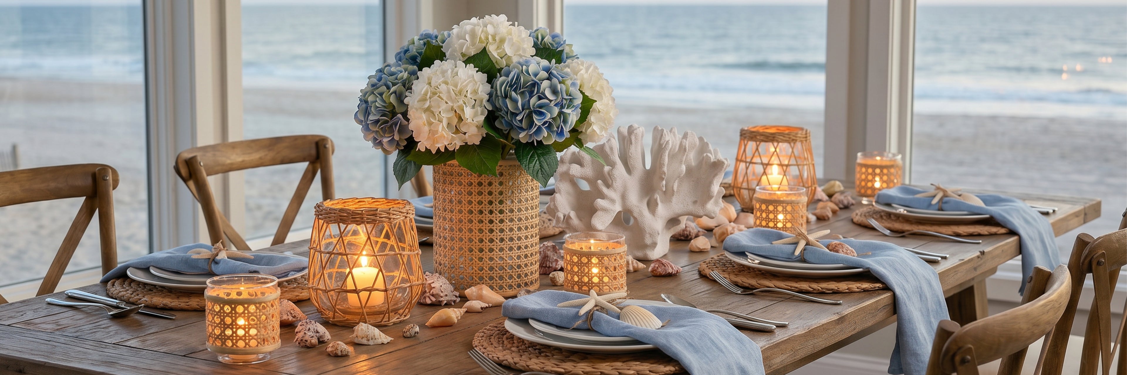 Dining table set for a meal with ocean view, featuring candles and a floral arrangement.