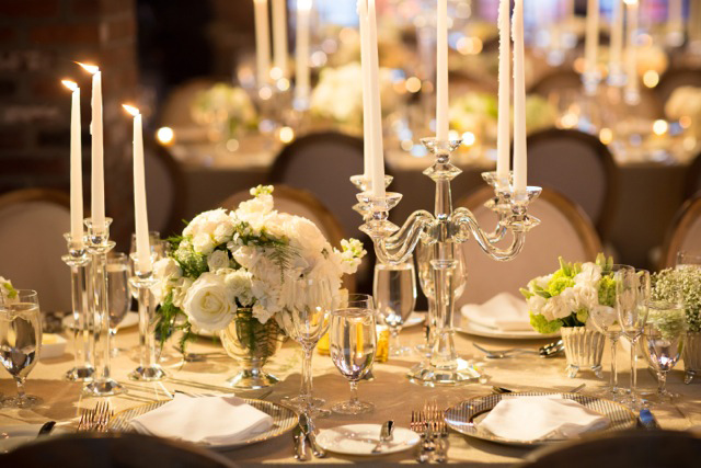 Centerpieces included white & green blooms in silver bowls.