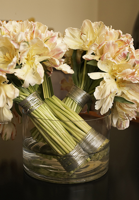 This arrangement features three bouquets of parrot tulips wrapped with aluminum wire.