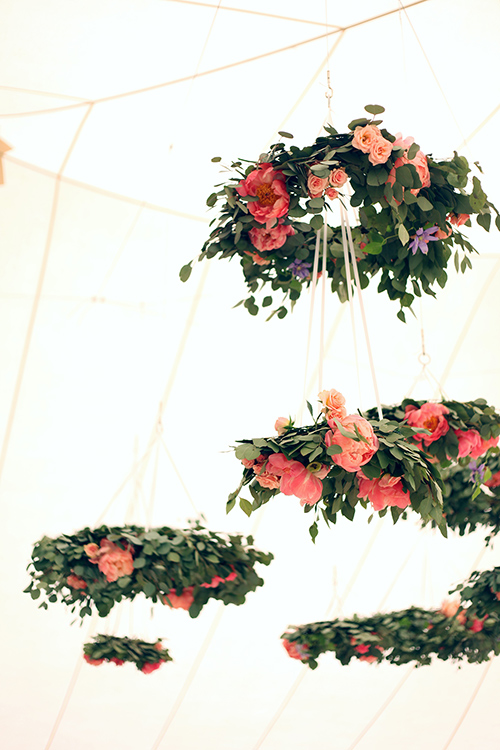 Floral chandeliers with eucalyptus, peonies, clematis, and roses
