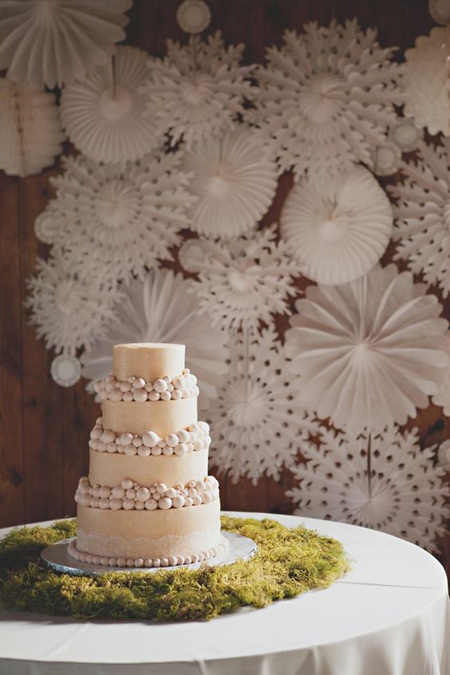 Moss surrounds a wedding cake. (via Ruffled)