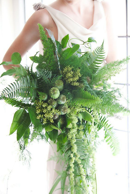 bride holding bouquet of all greens including ferns poppy pods amaranth and seeded eucalyptus