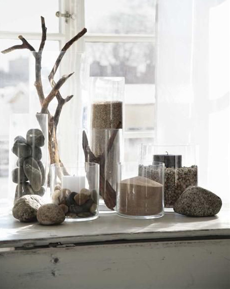 stones sand driftwood candle display