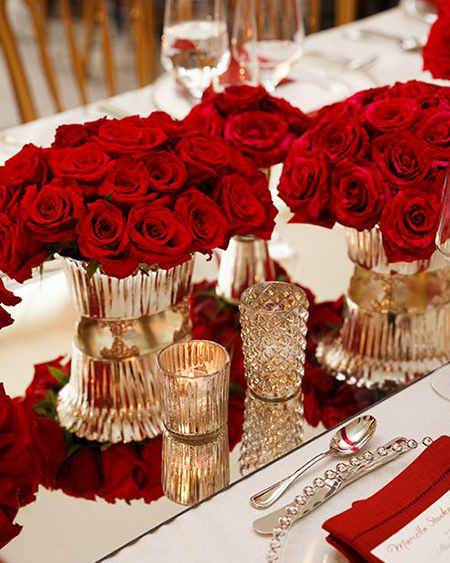 red rose centerpieces on long tables for red wedding event decor