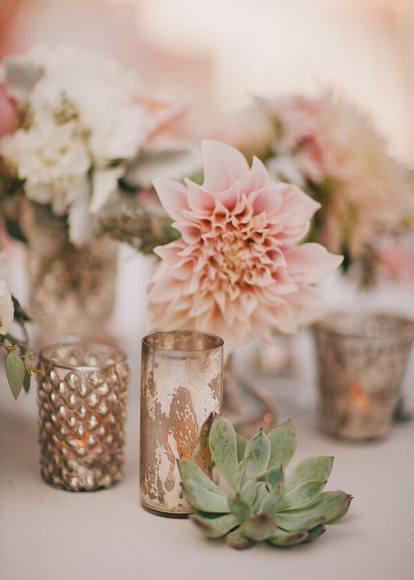 vintage-look mercury glass votives glowing with tea lights, dahlias, and succulents