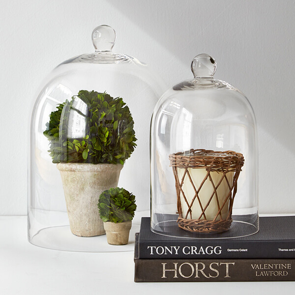 glass bell jars with scented candle and boxwood topiaries