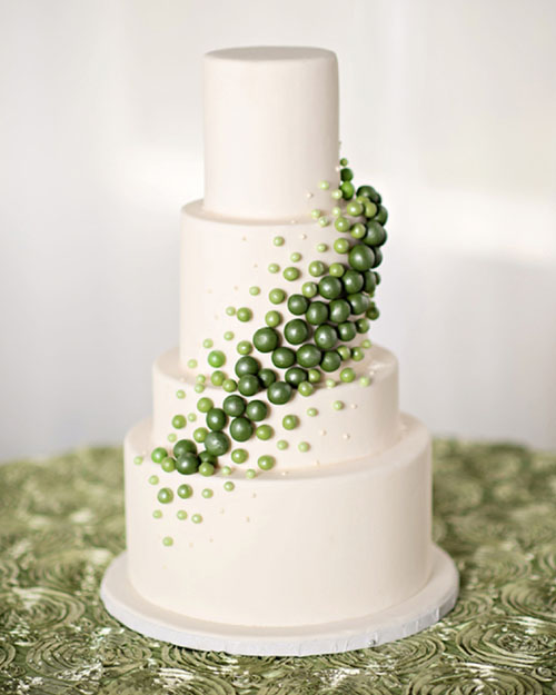 white wedding cake adorned with green mini balls