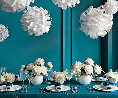 white and teal winter wedding with ribbon pompons hanging from the ceiling