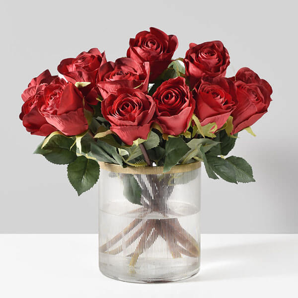 faux red roses bouquet in glass vase with gold rim