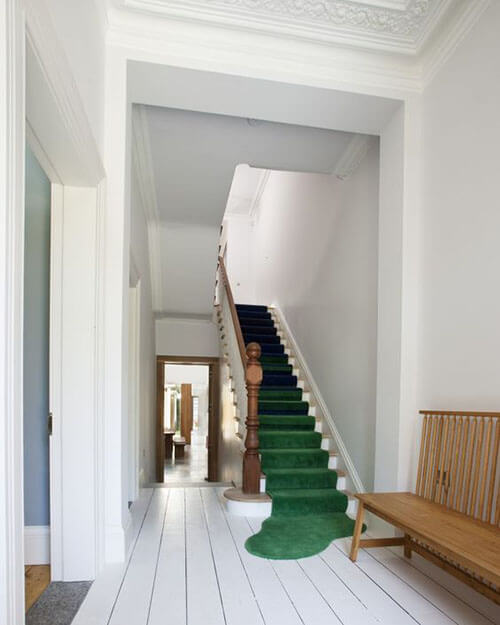 green carpeted white staircase 