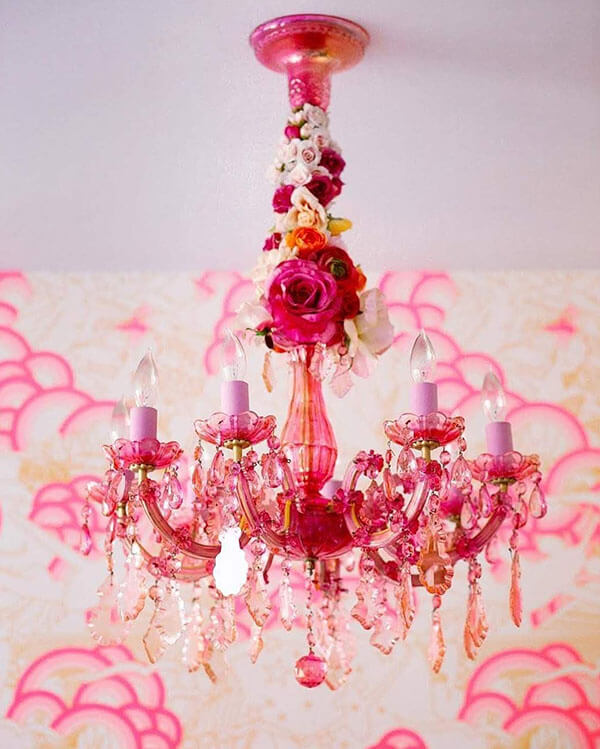 pink glass chandelier with cord covered in silk flowers