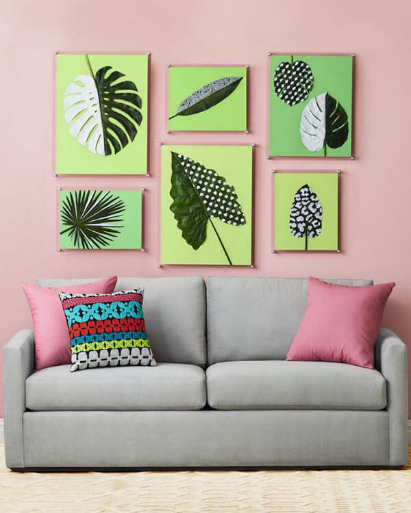 painted fake leaves hanging as wall art above a sofa from hgtv magazine