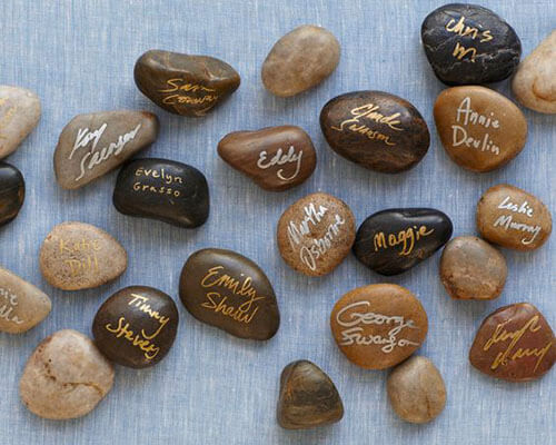 river stones with wedding guest names