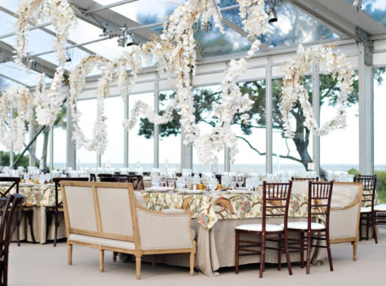 tent wedding reception with orchid garlands