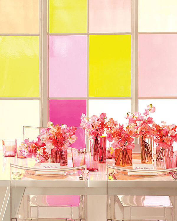 watercolor windows with shades of citrus and pink illuminating centerpieces, escort cards, cocktails, and even a cake