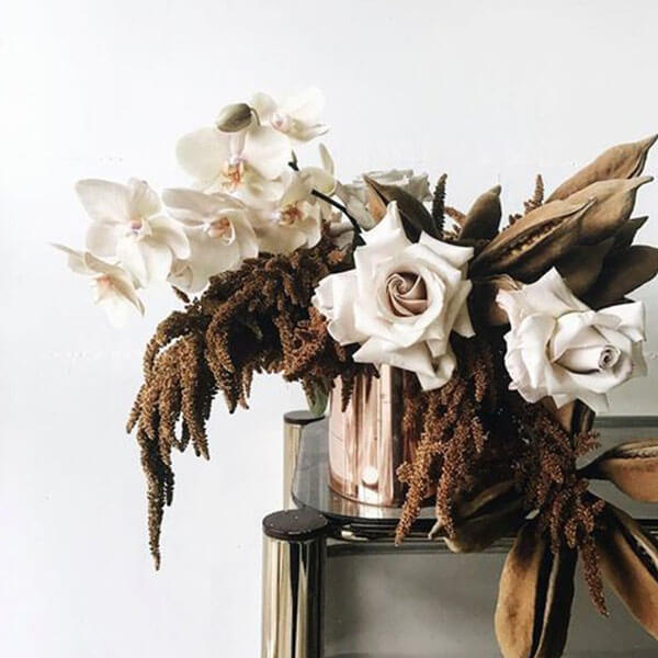 gold vase with brown amaranth white roses and orchids and dried pods