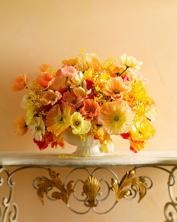 peach pale yellow and orange poppies arrangement in a white ceramic bowl from martha stewart weddings