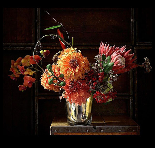 dahlias proteas orchids and heliconia in a mercury glass vase