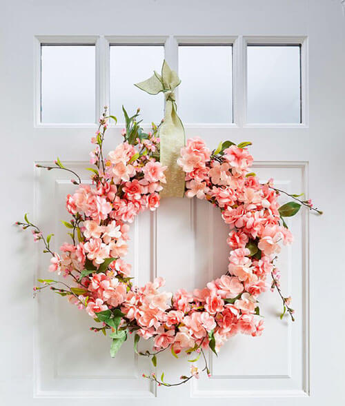 faux pink cherry blossom wreath on white door