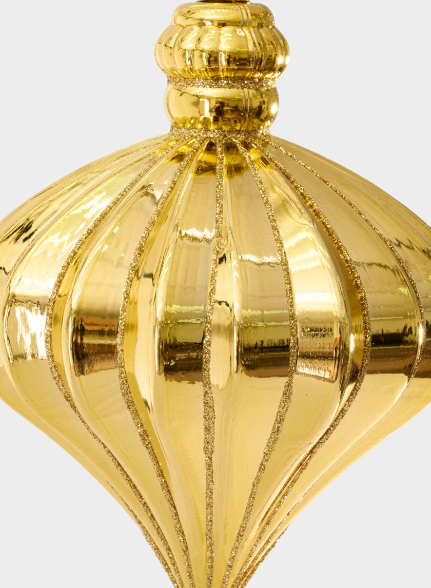 Close-up of the 7in Gold Glittred Plastic Onion Ornament, featuring vertical ridges and glittery accents, set against a plain white background.