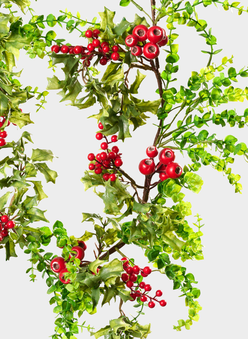 The 5ft Eucalyptus and Red Berry Garland features green leafy eucalyptus branches paired with clusters of bright red berries, arranged diagonally across a white background to create a vibrant, festive appearance.