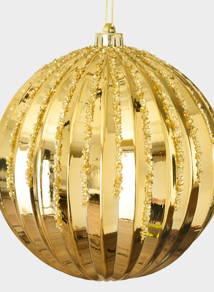 An 8in Plastic "Real Glass Look" Glitter Glazed Gold Ornament with vertical ridges and glittering beaded lines hangs from a yellow string against a plain light background.