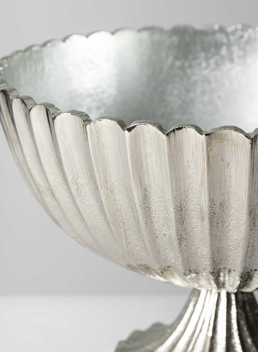 Close-up of the 12in Palermo Brushed Silver Scallop Compote Metal Bowl featuring a scalloped edge and textured, fluted surface, set against a plain light gray background.