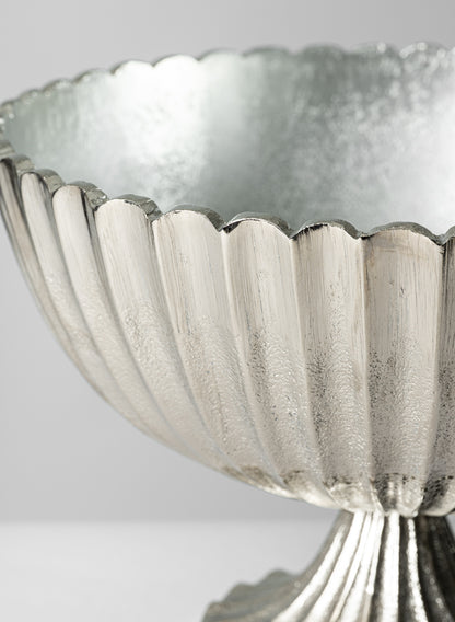 Close-up of the 12in Palermo Brushed Silver Scallop Compote Metal Bowl featuring a scalloped edge and textured, fluted surface, set against a plain light gray background.