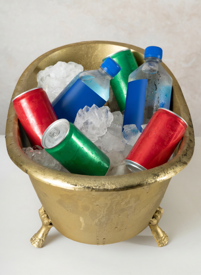 An 11.5in Wide Atelier Decorative Metal Mini Royal Bathtub holds ice, red and green soda cans, and blue-labeled plastic water bottles.