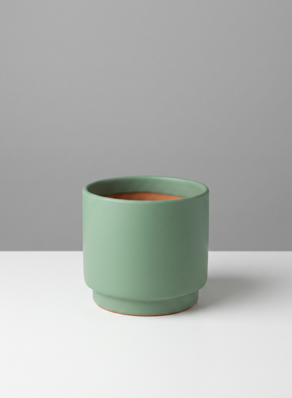 A set of six 4-inch tall Florist Choice matte teal green cachepots, each with a wide opening, sits on a white surface against a gray background.