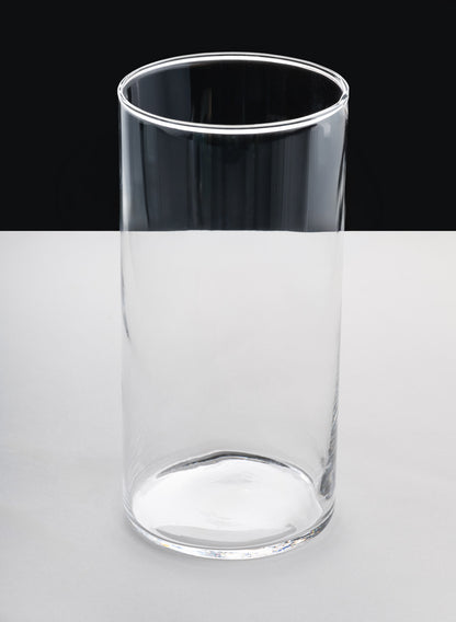 A set of 6 Best Value Glass Cylinder Vases is displayed, each empty and clear, sitting on a flat, light gray surface with a black background.