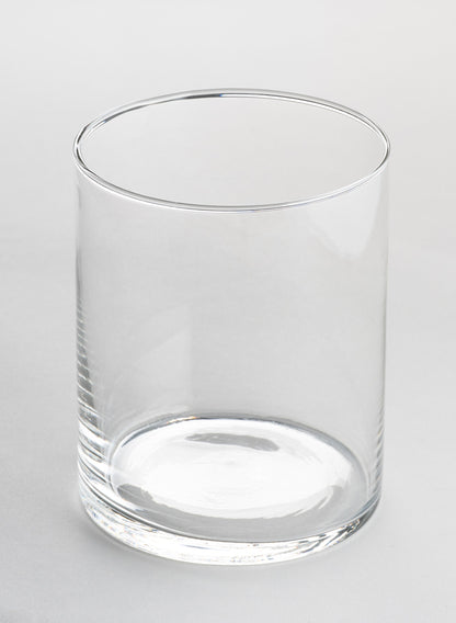 A set of 6 Best Value Glass Cylinder Vases sits empty on a plain, light gray surface, photographed against a neutral background.