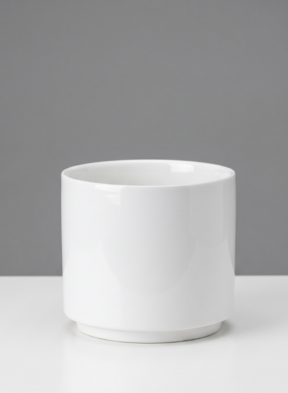 A set of four 4-inch-tall Florist Choice gloss white ceramic cylinders is displayed on a white surface against a gray background.