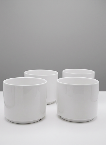 Four 4-inch tall Florist Choice gloss white cylinder vases, sold as a set of four, are arranged in a square on a white surface against a light gray background.