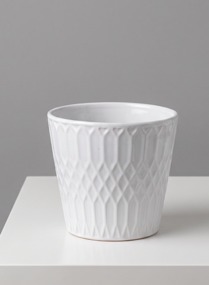 A set of four 4.5-inch tall Florist Choice white cachepots, featuring a geometric textured pattern, is displayed on a white surface against a plain gray background.
