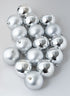A set of 3in round matte and shiny silver ornament balls arranged on a light gray surface.
