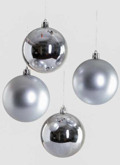 Four 3in Round Matte &amp; Shiny Silver Ornament Balls hang against a plain light gray background; two feature a shiny, reflective finish and two have a matte surface.