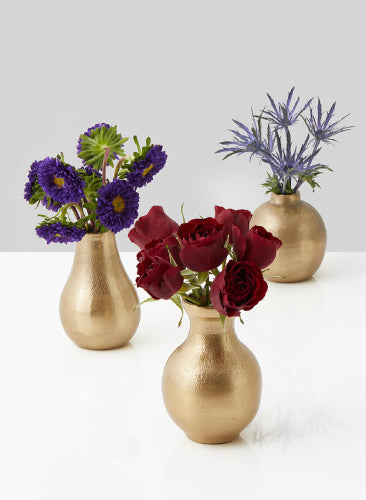Three gold vases with flowers on a white background
