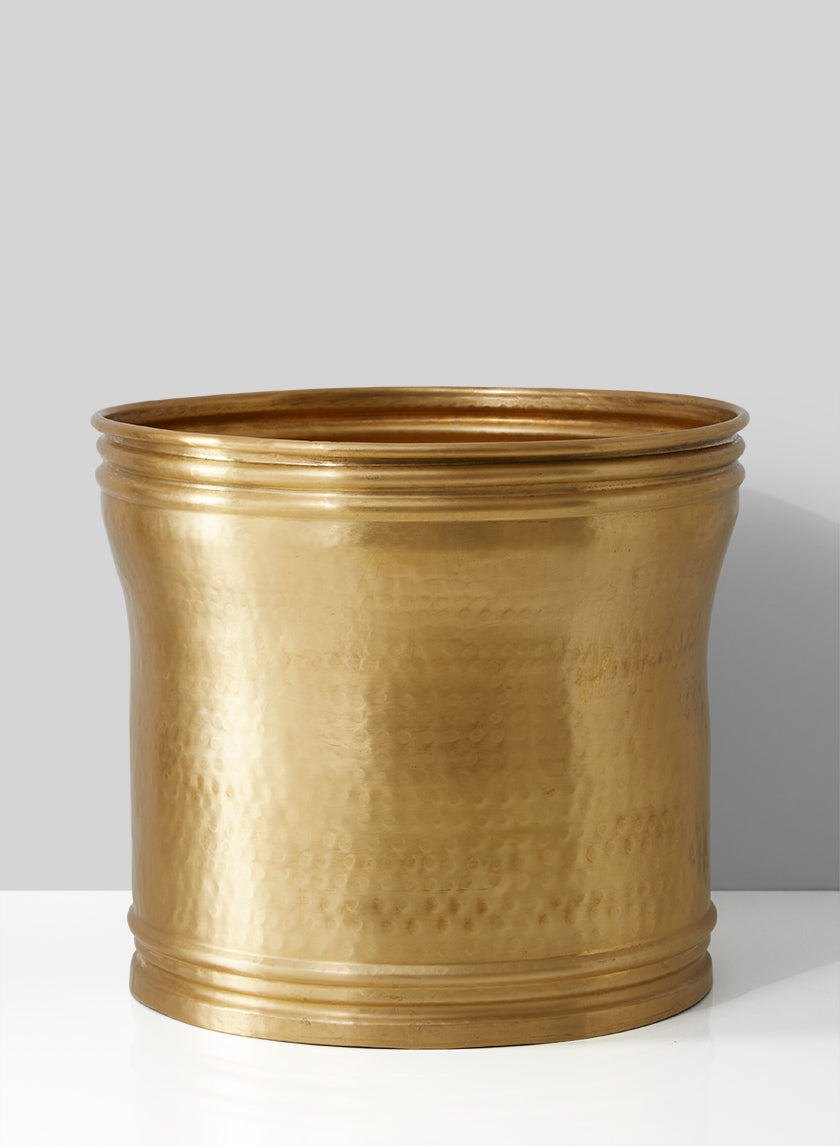 The Brass Look Antique Aluminum Planter features a large, round shape with a flared rim and subtle horizontal ridges, perfect for vintage-inspired décor. Displayed against a light grey background on a white surface.