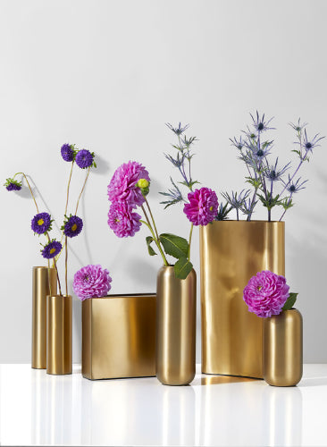 Set of gold vases with purple flowers on a white background