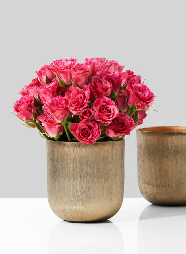 Bouquet of pink roses in a beige vase on a light gray background